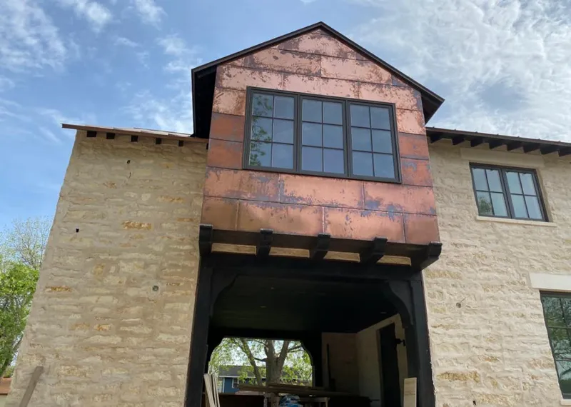 Copper metal panel facade on a stone building for Metal Roof Coating in Landen